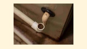 HVAC technician inspecting an air conditioner making strange noises in Pomona, CA